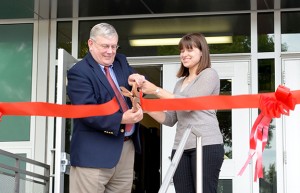 President Earl H. Potter III and Case-Hill Hall Director Margaret Sykes cut a red ribbon to celebrate the re-opening of Case-Hill Hall in August. Photo by Kay Printy