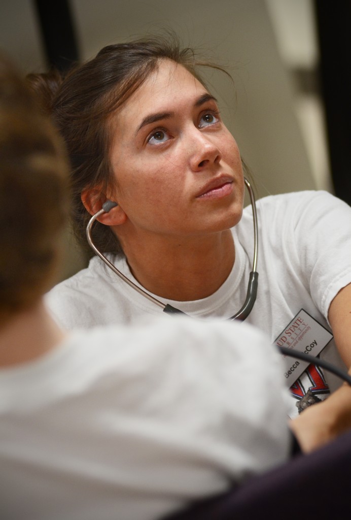 Graduate student Becca McCoy check's Nancy Holden's heart rate before beginning testing. Photo by Adam Hammer '05