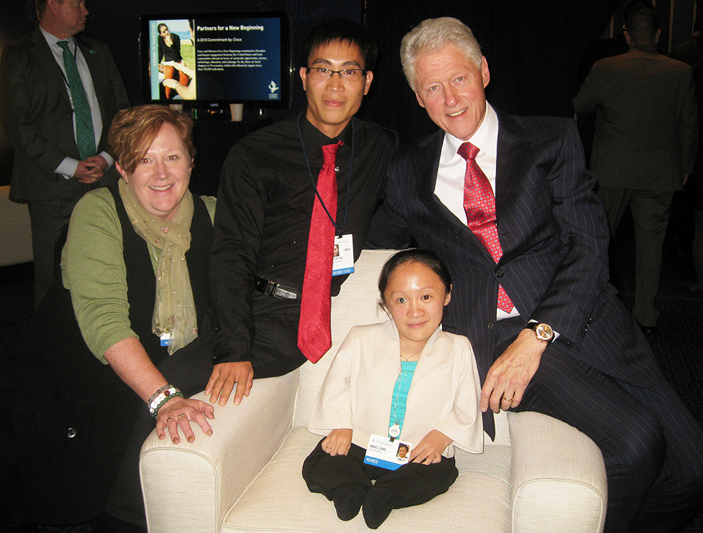 Professor Kathy Johnson with Zhao Chun Li "Angel" (seated), Angel's husband Mo En Yao (center) and former President Bill Clinton backstage at the Clinton Global Initiative conference. Submitted photo