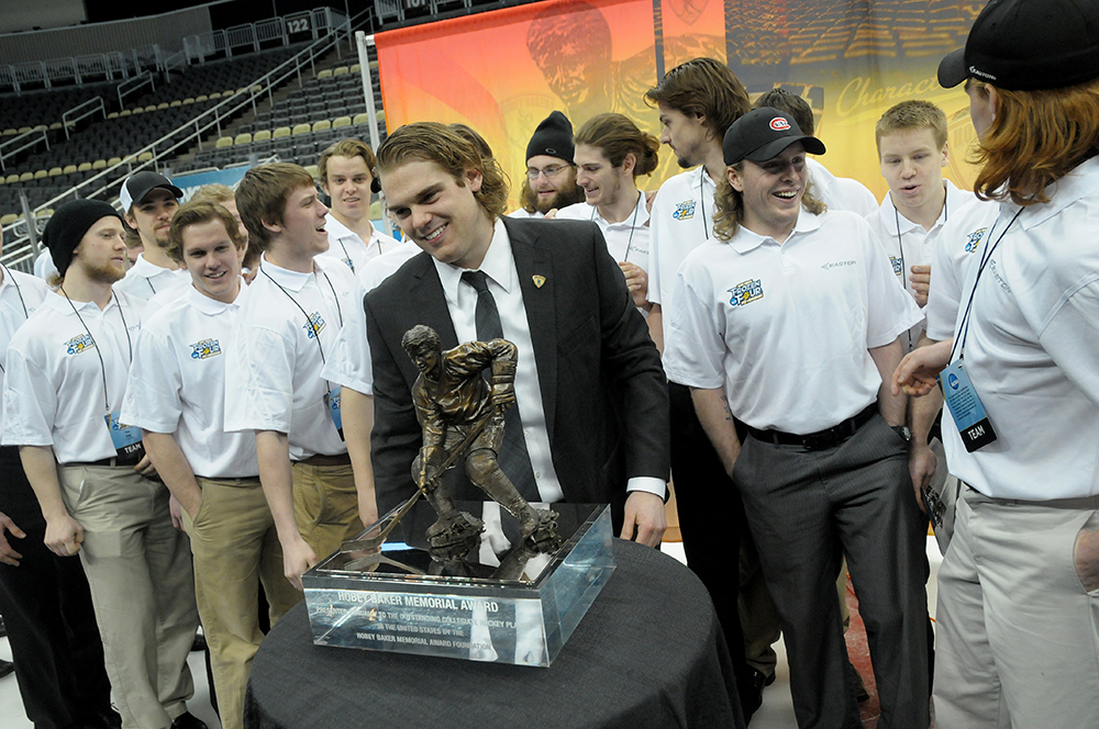 Drew LeBlanc celebrates his Hobey Baker Award win with his team. Photo by Adam Hammer '05