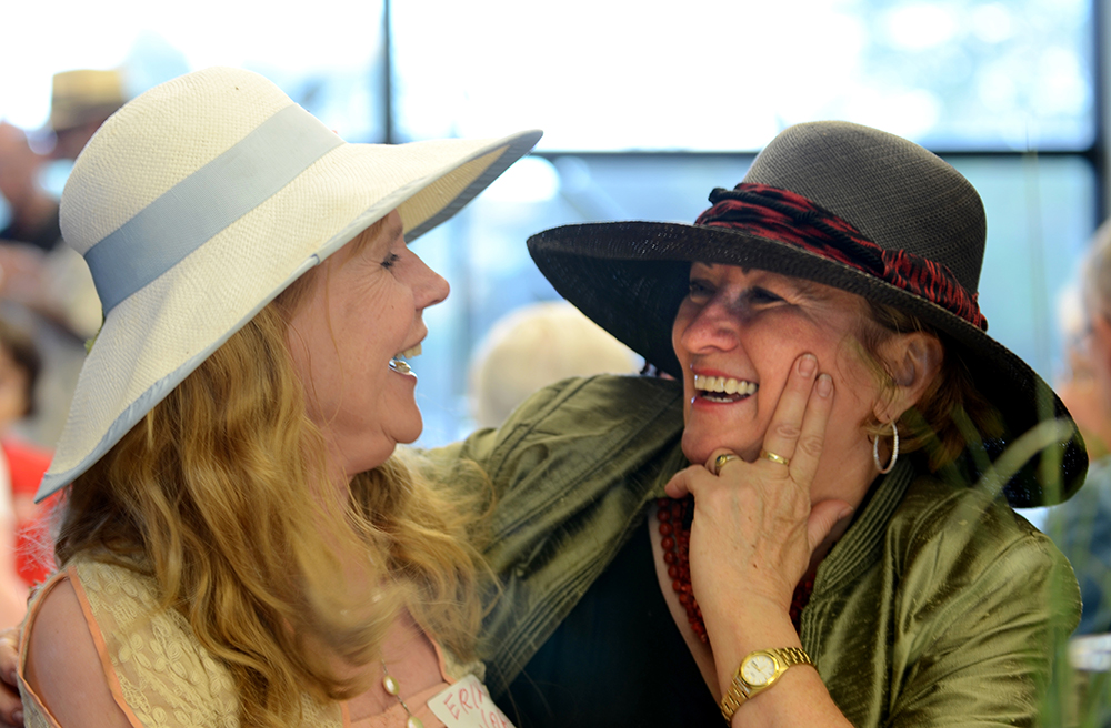 Retired communication studies professor Erika Vora compares hats with Margaret Vos, Atwood Memorial Center. The two visited at a June 27 reception for the 40th Lemonade Concert and Art Fair. Photo by Jeff Wood ’81 ’87 ’85