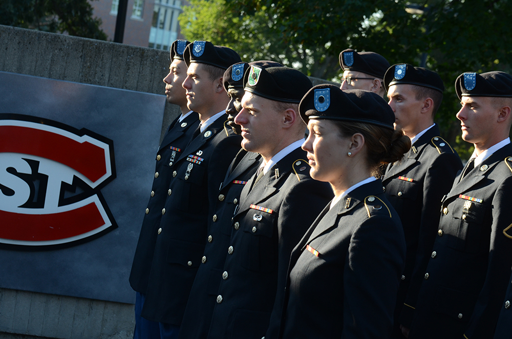 Student Veterans Organization members host a flag raising ceremony in front of the Administrative Services building in honor of Patriots Day on Sept. 11. Photo by Adam Hammer '05