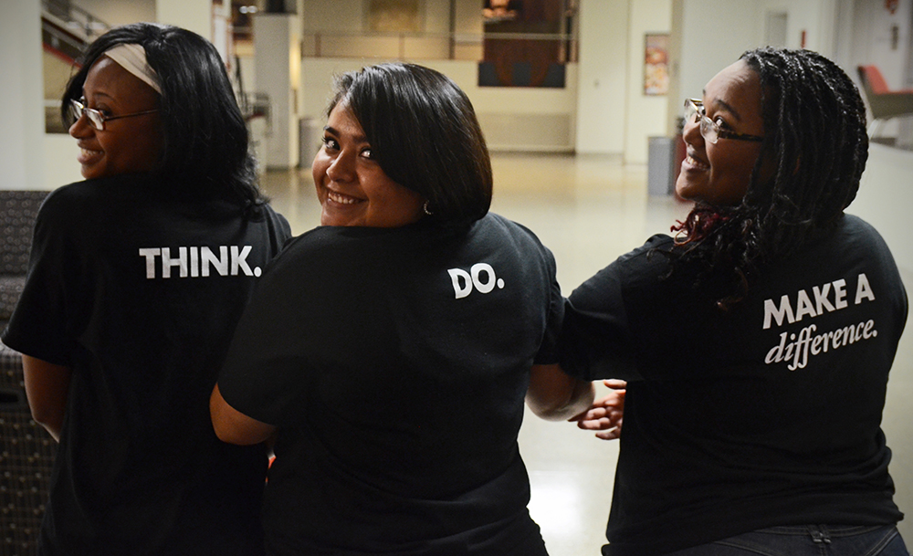 Students MarQueda Ratliff, Sara Salas-Ramirez and Sara Biru don their “Think. Do. Make a Difference.” t-shirts. Photo by Adam Hammer ’05
