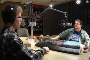 Jesse "Scooter" Wheeler looks at Trevor Klopp over the instrument panel in the RadioX studio.
