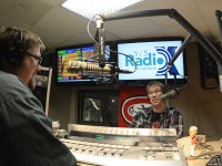 Jesse "Scooter" Wheeler, left, and Trevor Klopp speak into microphones in the new RadioX studio.