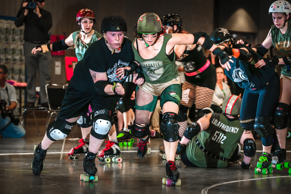 St. Cloud State student Kara Kempenich fights to break through a competitor as she competes in a SCAR Dolls bout as Bianca the B. Photo courtesy of SDE-Nick Campbell