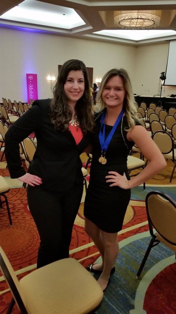 St. Cloud State DECA President Kelsey Jones (left) and Vice President Alexa Dieterichs receive Student Leadership Awards for 2015