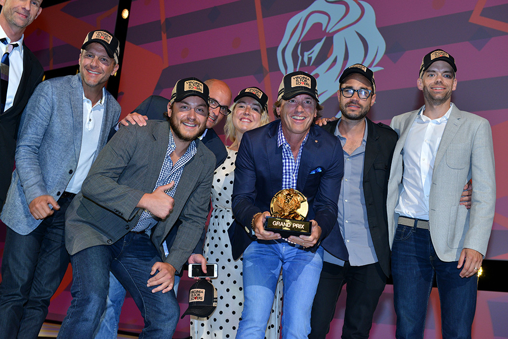 Joe Alexander holds the Cannes Grand Prix Award with The Martin Agency creative team. 