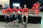 Team XDrive shows off its awards and robots.