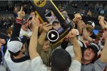 A screen capture of the video with wrestlers holding up the NCAA trophy