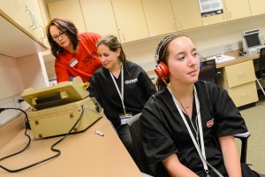 Scrubs Camp attendees learn to conduct pure tone audiometry (PTA) tests using an audiometer. Photo by Nick Lenz '11