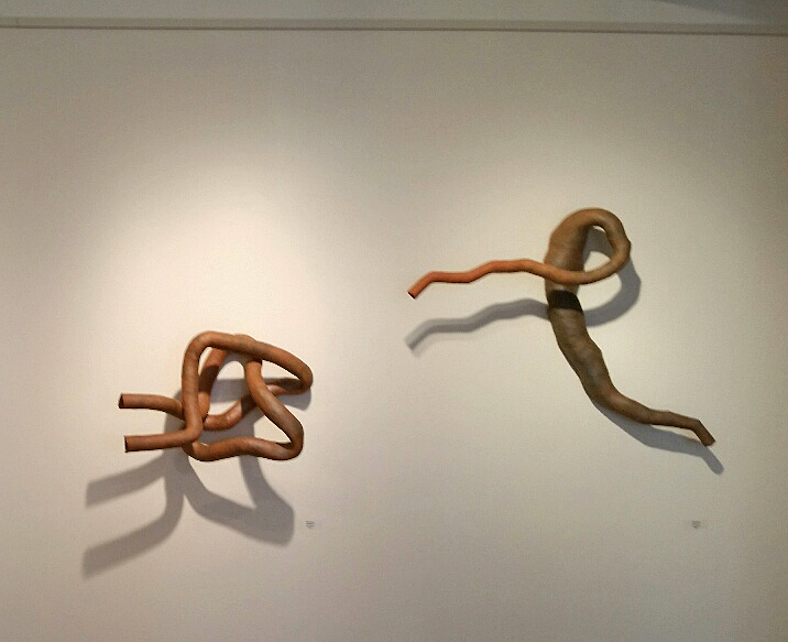 Two of the untitled sculptures hang on the wall