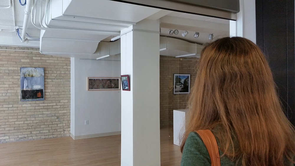A woman looks at the artwork