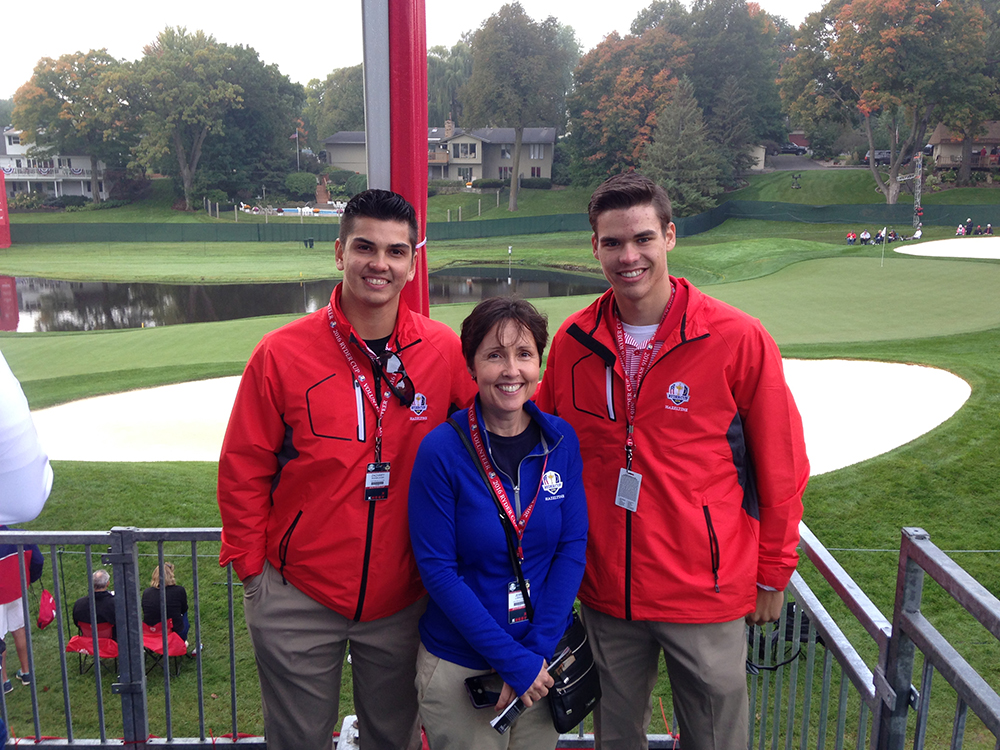 St. Cloud State students Kyle Boser and Zach Siggelkow pose with Monica Devers, dean of the School of Health and Human Services at the 15th green at the Ryder Cup. Submitted photo