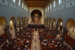 A photo of the entire nave with the choir singing at the front of the church