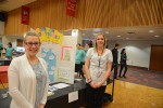 Jessica Shor and Reagan Vanteeling stand on either side of their display