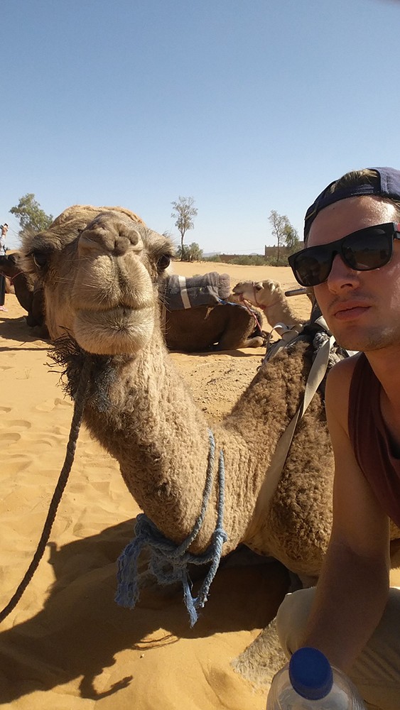 Adam Fitzpatrick takes a selfie with a camel