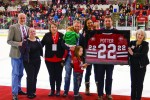 Potter's family hold a framed jersey on the ice