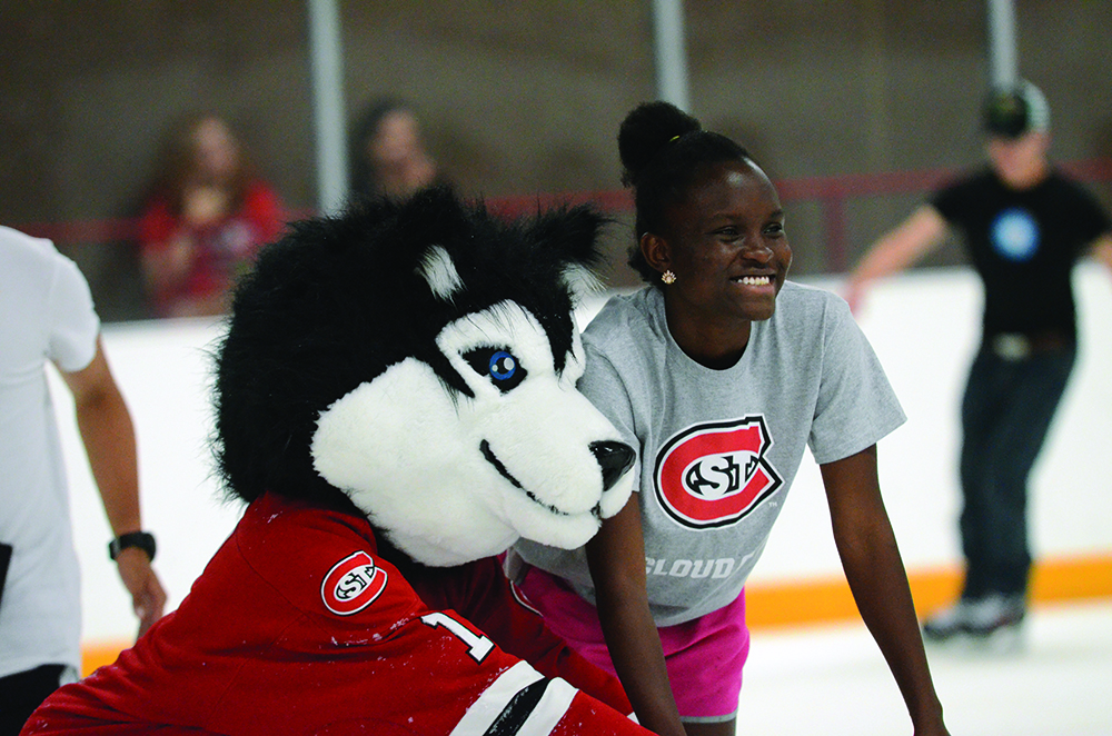 The blizzard mascot and students skate