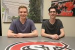 Lucas Reller and Ryan McConnon sit at a table