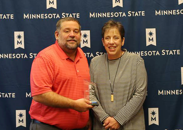 Jeff Wagner holding his award with Laura King