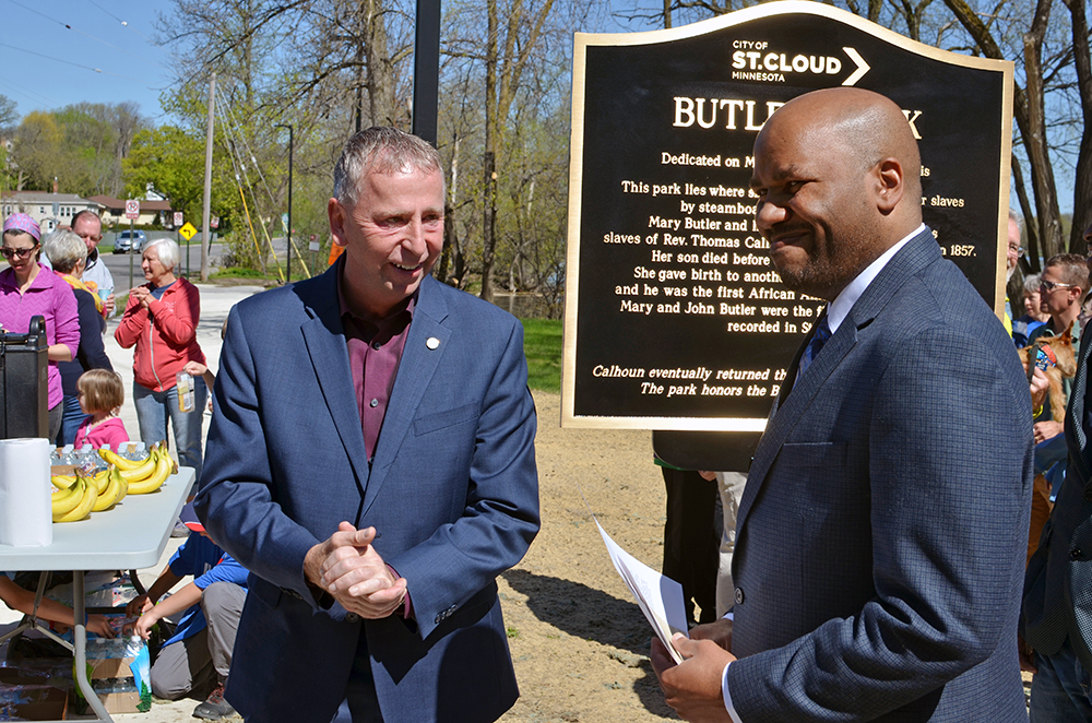 Dave Kleis and Chris Lehman stand in front of the Butler Park sign