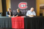 President Robbyn Wacker and representatives from AAM and Nahan Printing sign documents