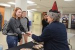 A student accepts an offered cookie