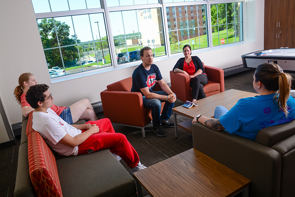 Thaddeus Rybka and students sit in the Recovery Resource Center