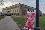 A sign pointing to the Wi-Fi parking with Miller Center in the background