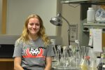 Clara Welhouse with some beakers in a lab
