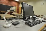 A document camera sits next to a computer monitor