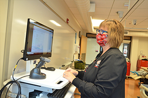 Nursing faculty enters data into Sim Electronic Medical Records software 