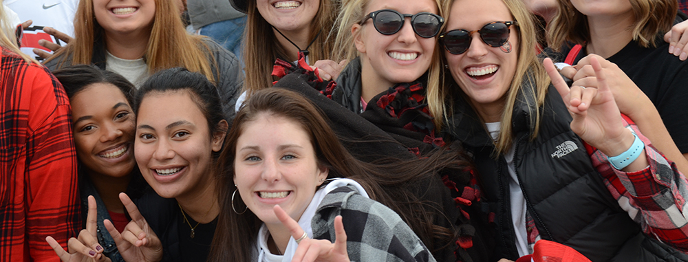 Group of St. Cloud State Students making the "Blizzard" hand gesture