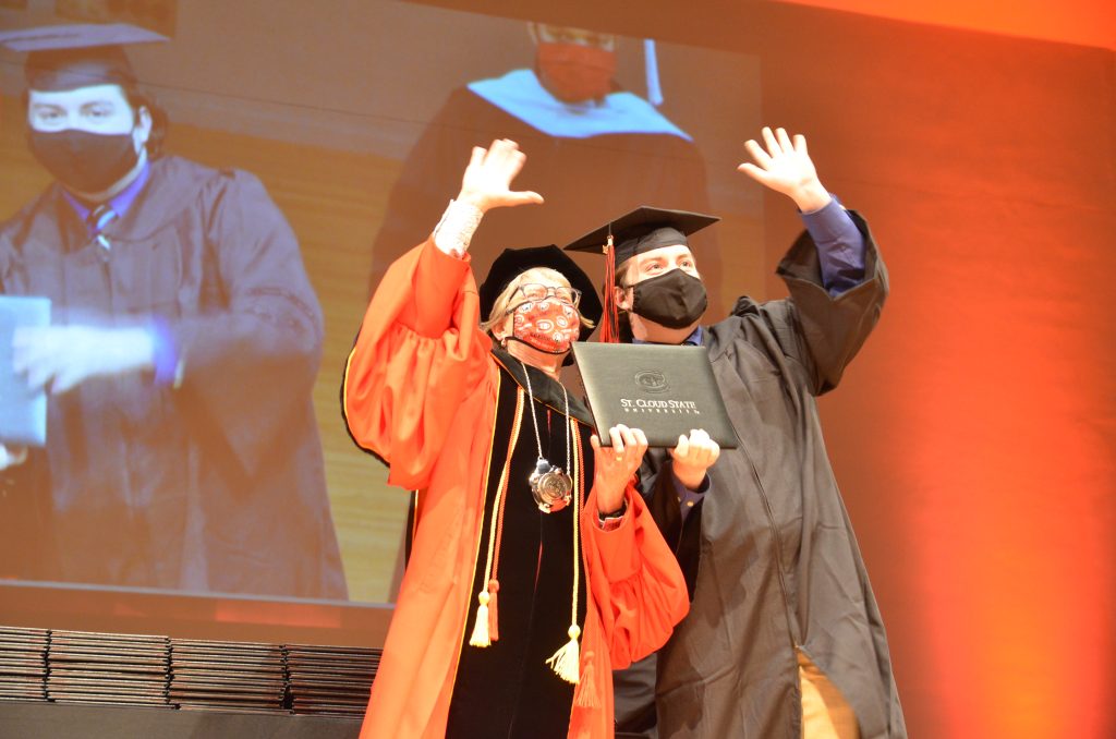 President Wacker with Student and Diploma - Spring 2021 Commencement