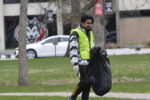 Student picking up garbage in Barden Park
