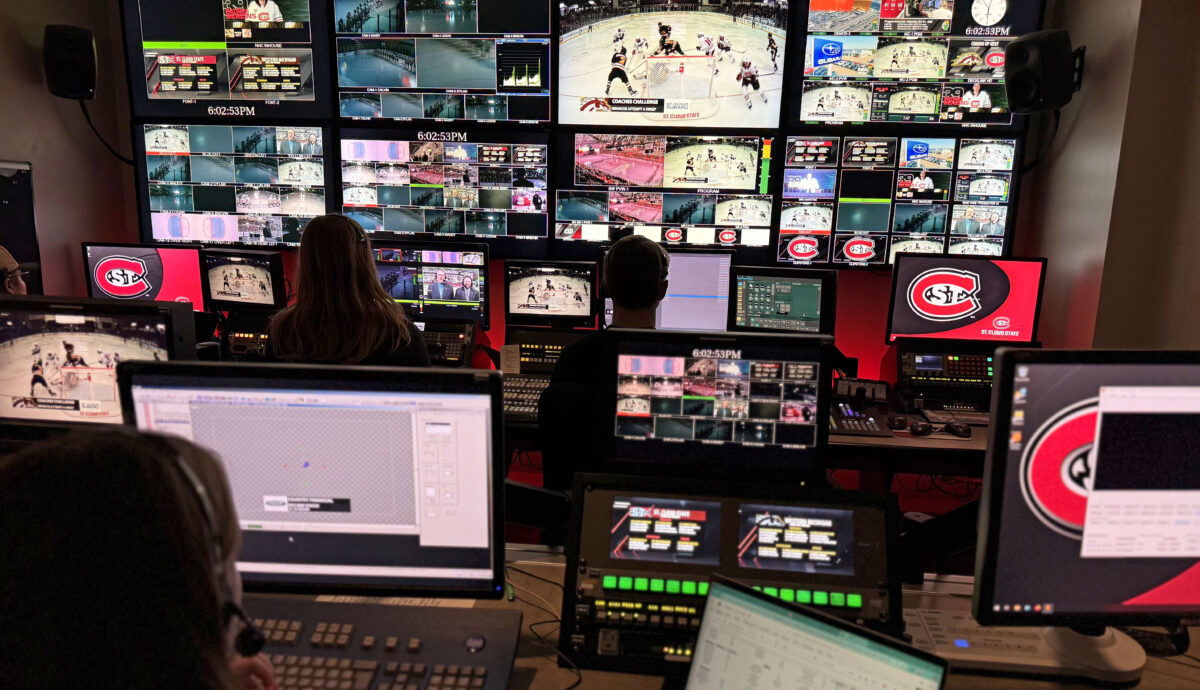 Students work in the UTVS control room with dozens of monitors and tv screens during an SCSU Men's Hockey game