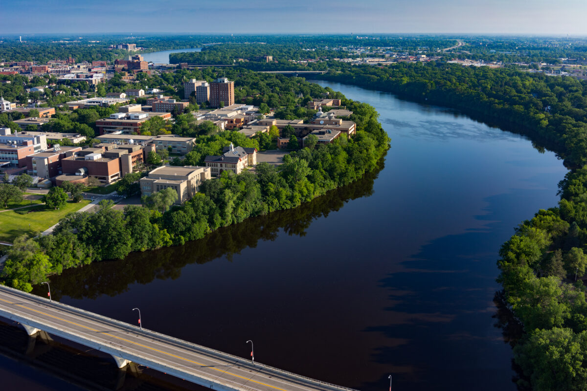 An aerial view of the St. Cloud State campus with the Mississippi River and the surrounding area visible