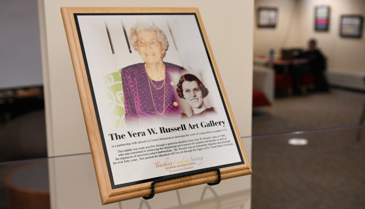 A plaque with two photos of Vera W. Russell is on display in the Miller Center