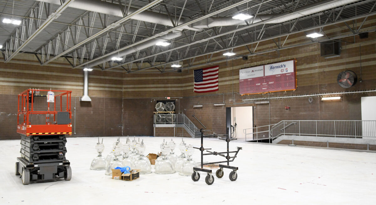 Dozens of large lights are sitting in the ground in the Herb Brooks National Hockey Center auxiliary rink