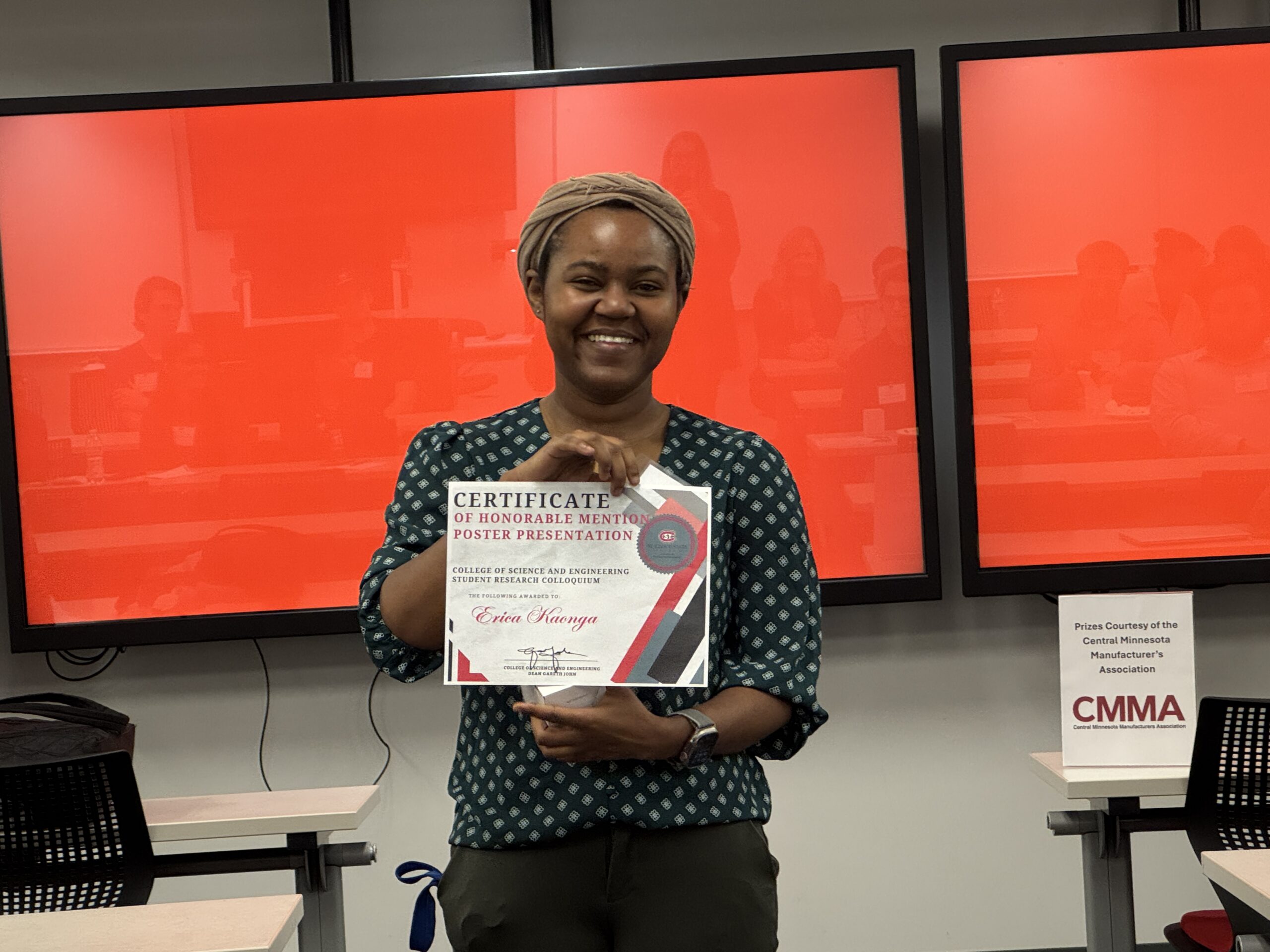 Woman smiling with an award.