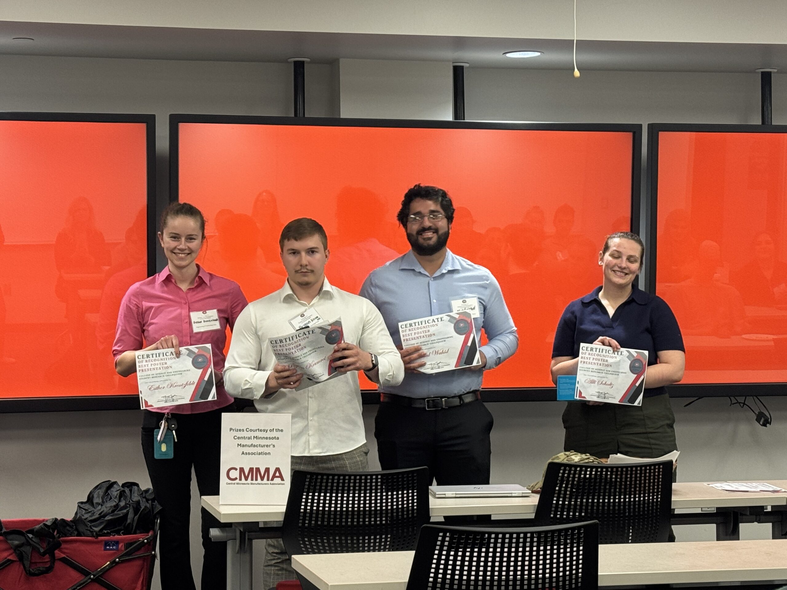 Students smiling with awards.