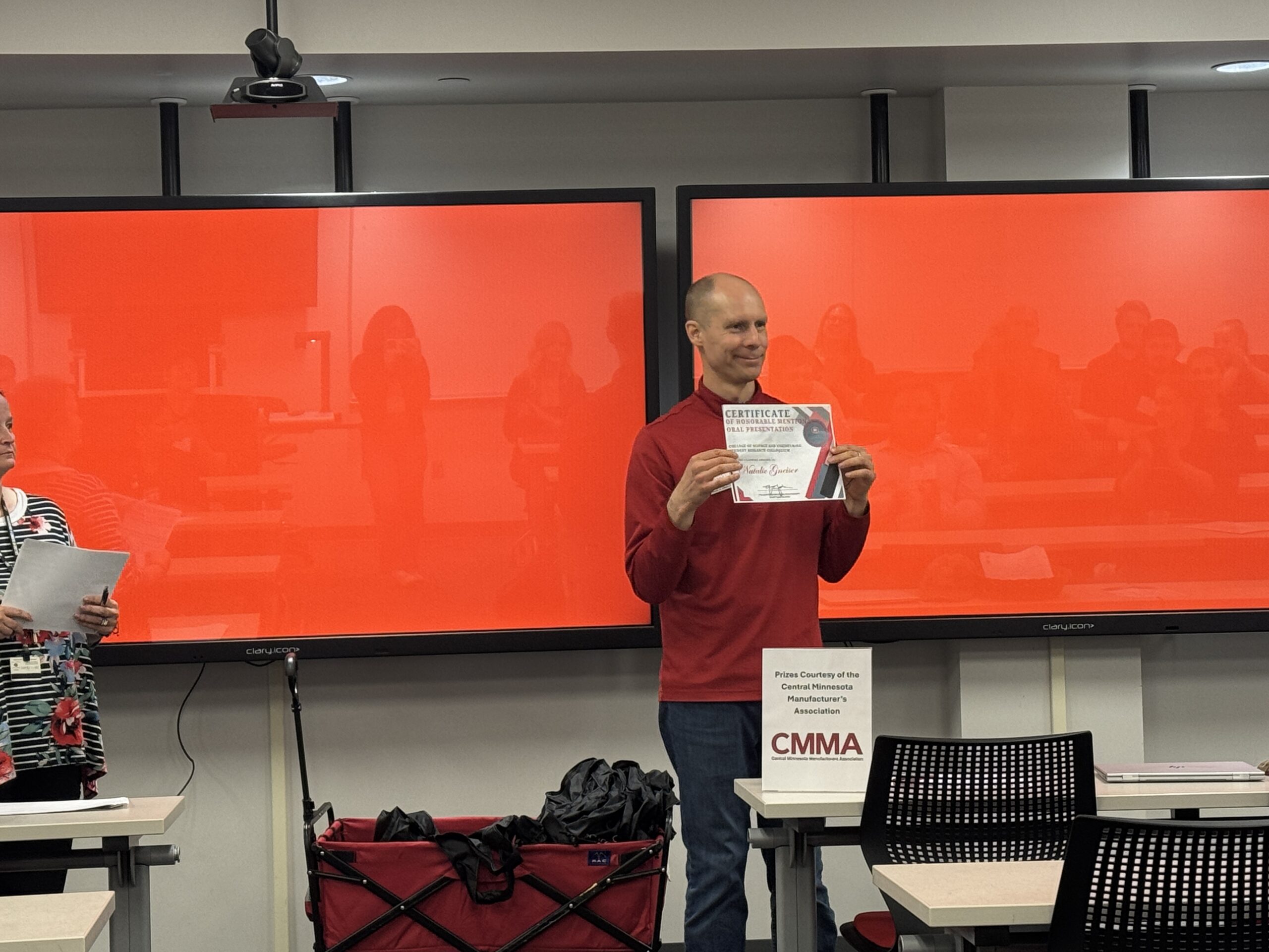Man smiling with an award.