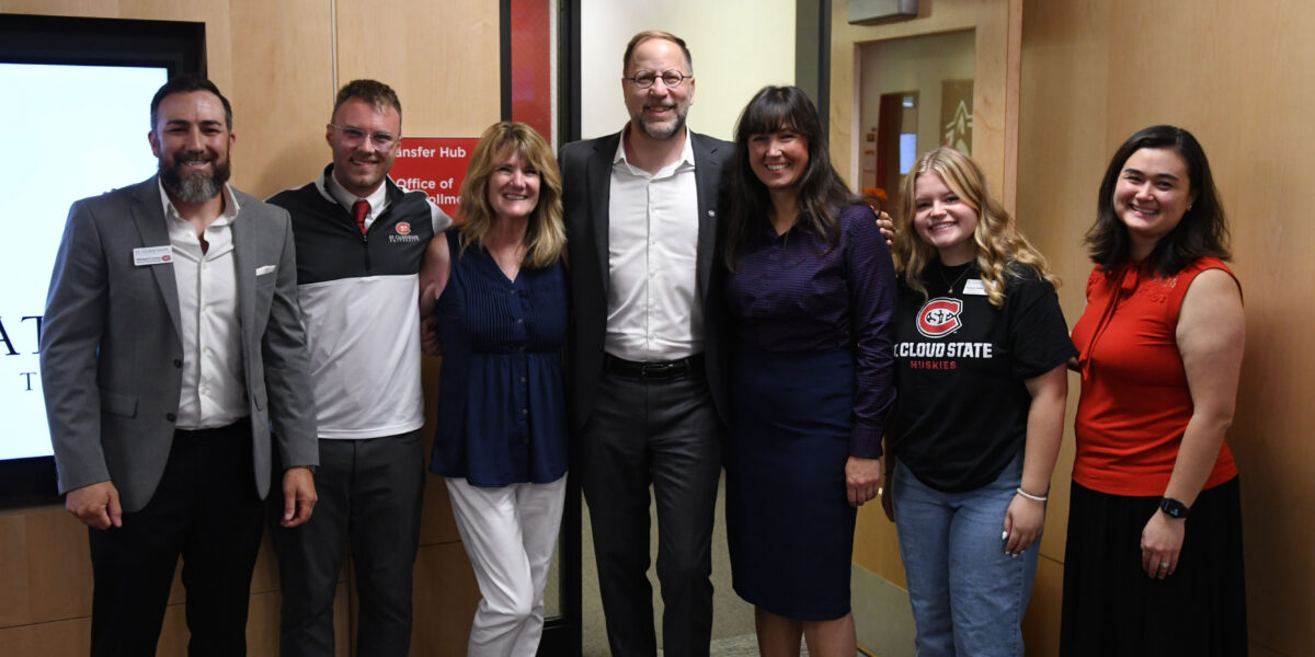 7 people stand in front of the new transfer hub at SCSU
