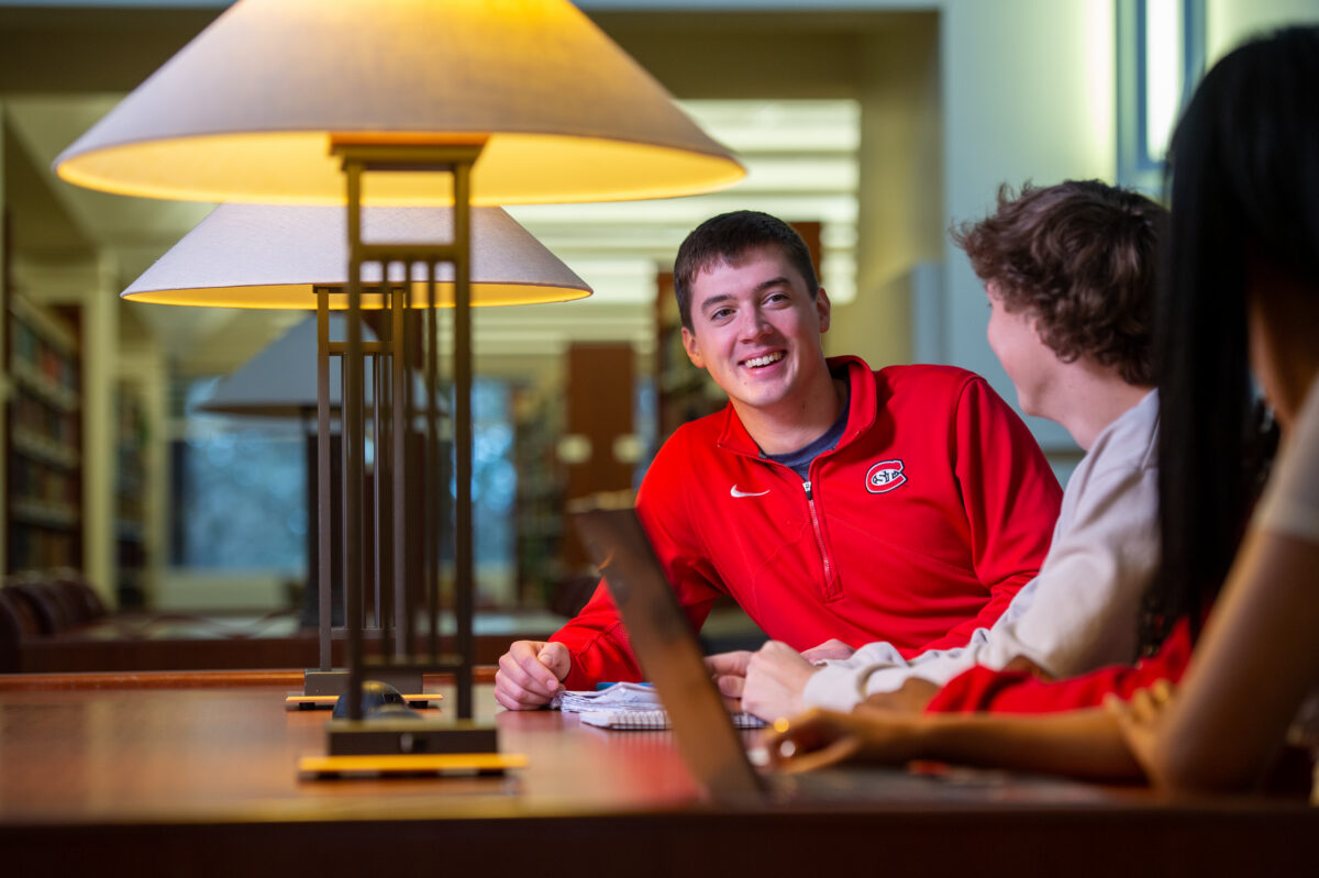 Students studying together at a table in the library.