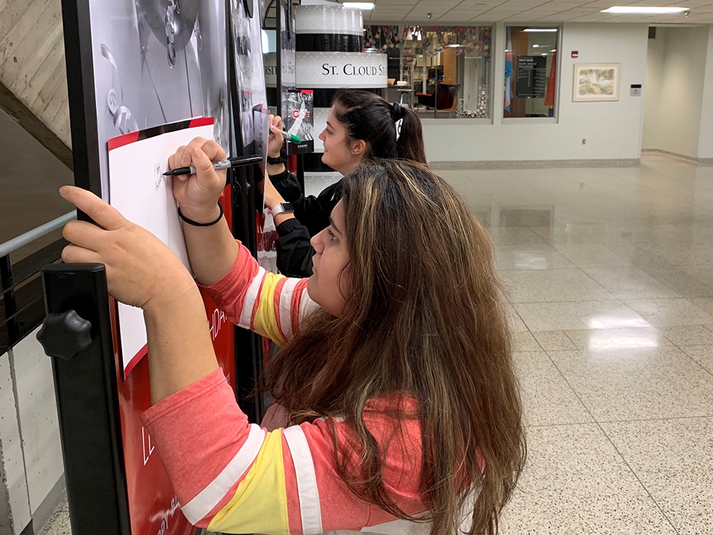Women signing cards