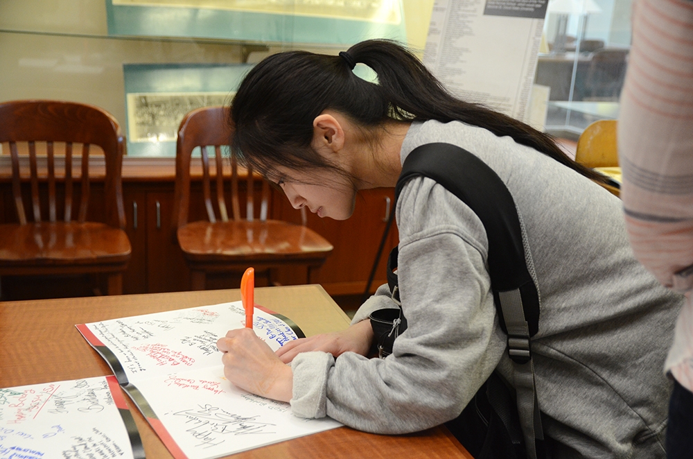 A woman signing a card