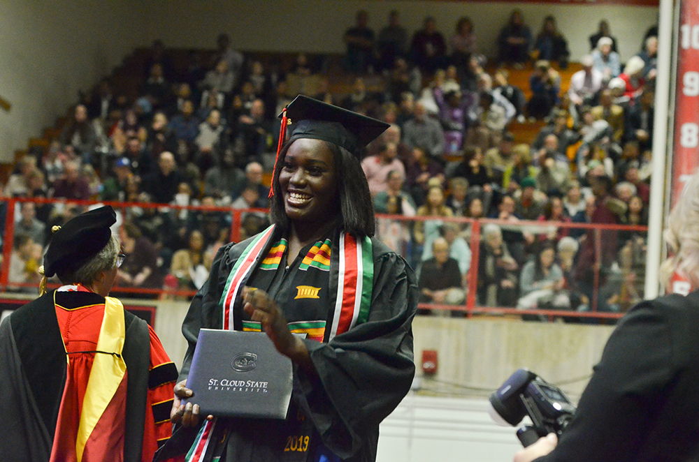 A graduate shows off her diploma