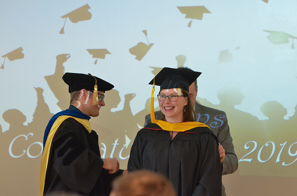 A graduate receives her hood