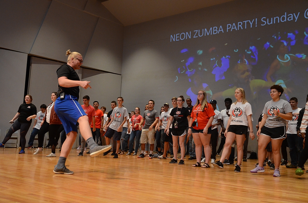 A student leads people in moves on stage